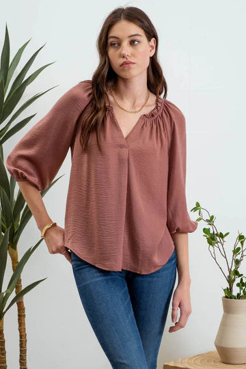 rust quarter length sleeve v neck top